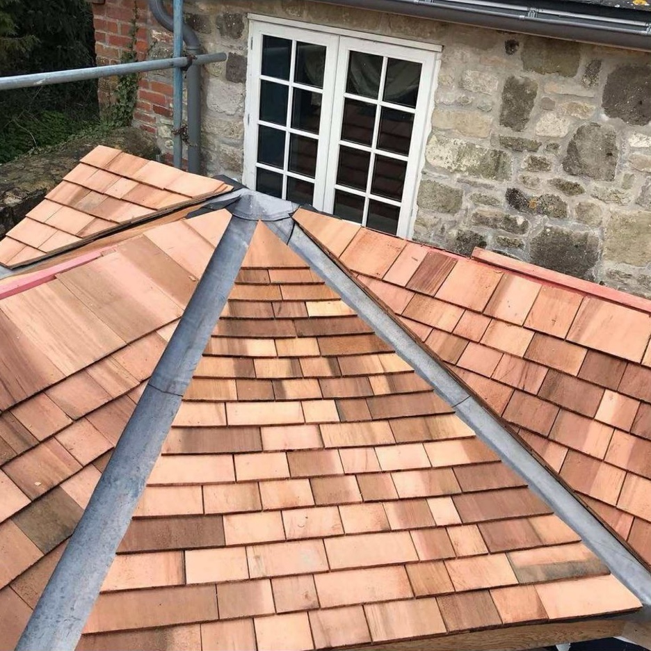 Pitched roof with red tiles and grey guttering