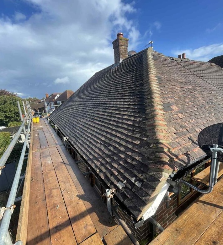 Roof with scaffolding around it following a roof repair job in Dorset
